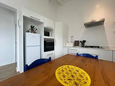 a kitchen with a wooden table and a yellow plate on it at Sunset Starfish Apartment in Cape Town