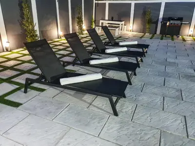 a row of chairs sitting on a patio at Howards Villas in Cape Town