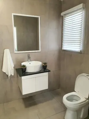a bathroom with a sink and a toilet at Howards Villas in Cape Town