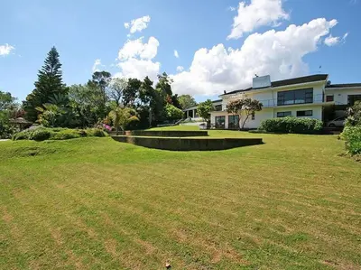 a large yard with a house in the background at Tolbos Garden in Cape Town
