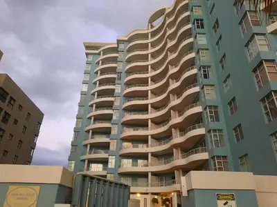 a tall apartment building with balconies at Cap d Azur beachfront apartment in Strand