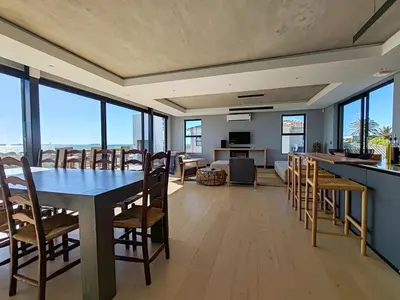 a dining room with a table and chairs at Drift Sunset Beach House in Sunset Beach