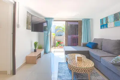 a living room with a couch and a table at Suikerbos Guesthouse in Cape Town