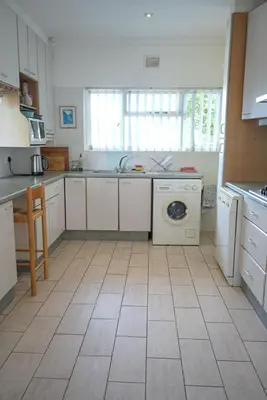 a kitchen with a dishwasher and a washer at Shonalanga (The setting sun) in Hermanus