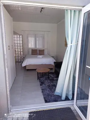 a view of a bedroom with a bed and a window at Stay Palm 2 in Cape Town