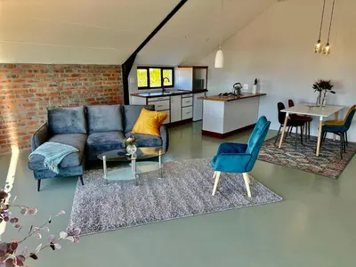 a living room with a couch and a table at World of Horses Stables in Stellenbosch