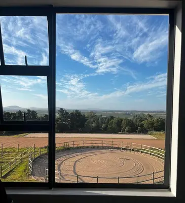 a view of a field from a window at World of Horses Stables in Stellenbosch