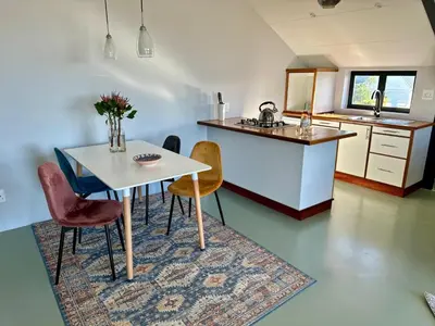 a kitchen and dining room with a table and chairs at World of Horses Stables in Stellenbosch