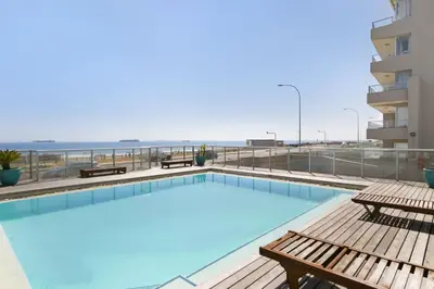 a swimming pool on the roof of a building at Sea Spray B306 in Bloubergstrand