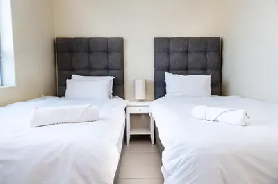 two beds sitting next to each other in a room at Sea Spray A308 in Bloubergstrand