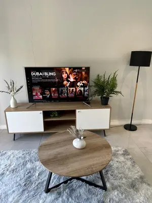 a living room with a tv and a coffee table at Urban Cosy City Haven in Cape Town