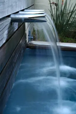 a water fountain in a pool in a backyard at Mosselberg on Grotto Beach in Hermanus