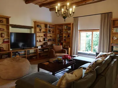 a living room filled with furniture and a flat screen tv at Navarre Residence in Stellenbosch
