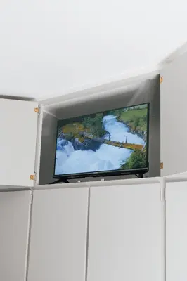 a flat screen tv in a room with a wall at Tranquil Private Rooms Hermanus in Hermanus