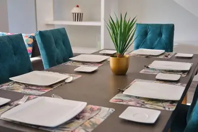 a table with laptops and a potted plant on it at Resort Style Penthouse - BackUp Power in Cape Town