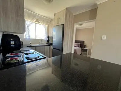 a kitchen with a black counter top in a room at #One6Eight in Hermanus