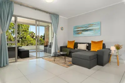 a living room with a couch and a table at Mayfair 219 in Cape Town