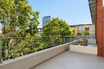 a balcony with a view of trees and buildings at Mayfair 219 in Cape Town