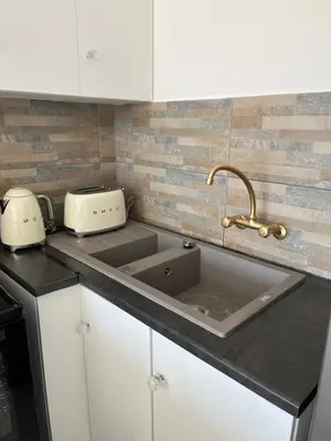 a kitchen counter with a sink and a toaster at Top Floor Executive apartment in Cape Town
