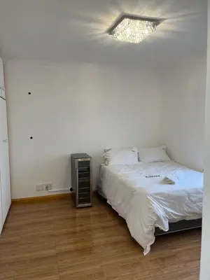 a bedroom with a bed and a television in it at Top Floor Executive apartment in Cape Town