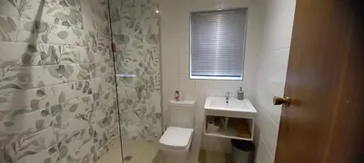 a bathroom with a toilet and a sink and a shower at Bellville Self Catering in Cape Town