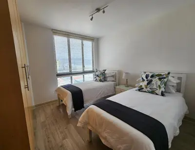 a bedroom with two beds and a window at Hibernian Towers 1203 in Strand