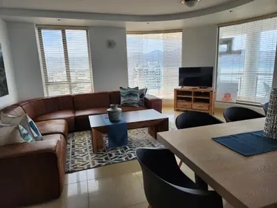 a living room with a couch and a tv at Hibernian Towers 1203 in Strand