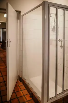 a shower stall in a bathroom with a glass door at Die Stal at Antioch in Franschhoek