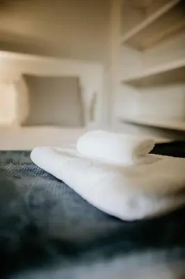 a white object sitting on top of a bed at Die Stal at Antioch in Franschhoek