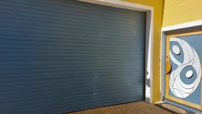 a garage door with a painting of eyes on it at The Waves of Schulphoek in Hermanus