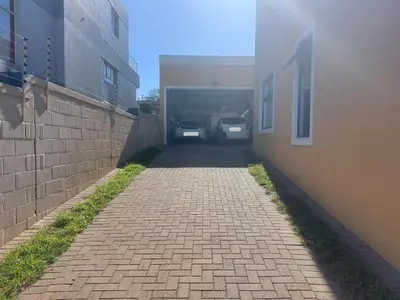 a brick alley with cars parked in a garage at The Waves of Schulphoek in Hermanus
