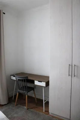 a desk with a chair next to a closet at Contemporary Central Apartment by ARPA Hospitalities in Stellenbosch