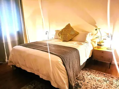 a bedroom with a large bed with at 28 on Ryneveld in Stellenbosch