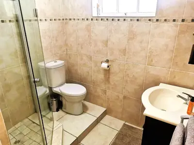 a bathroom with a toilet and a sink at 28 on Ryneveld in Stellenbosch