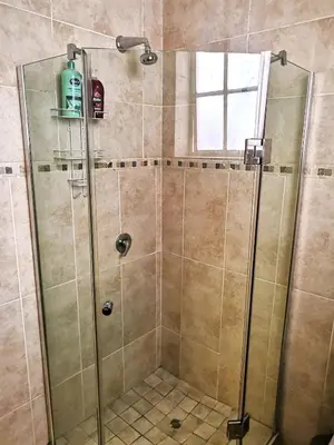 a shower with a glass door in a bathroom at 28 on Ryneveld in Stellenbosch