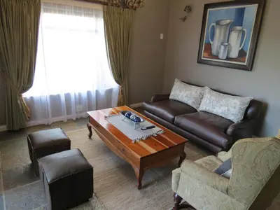 a living room with a couch and a coffee table at 10 on Berg in Villiersdorp