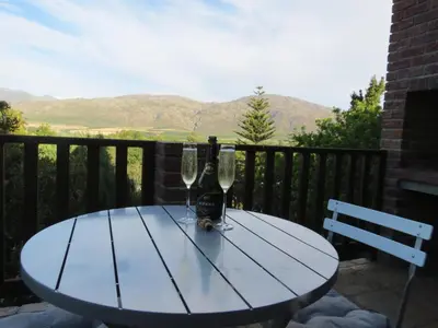a table with two wine glasses and a bottle at 10 on Berg in Villiersdorp
