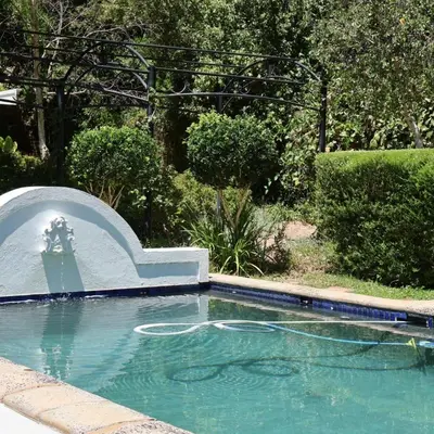 a swimming pool in a yard with a swimming pool at Kleinhof in Franschhoek