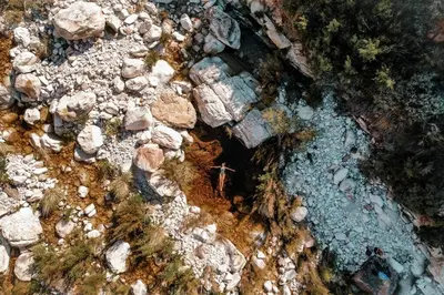 an overhead view of a river with rocks and trees at Luxury Solace Cabin - River Cabin in Rawsonville