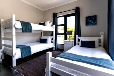 two bunk beds in a room with a window at Vue La Mer in Hermanus