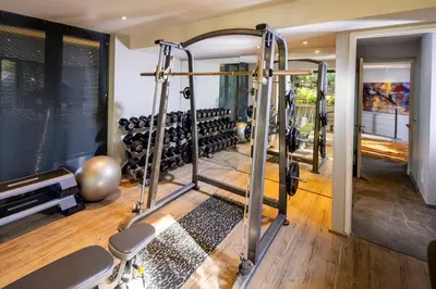 a gym with two tread machines in a room at Spanish Farm Boutique Hotel & Villas in Somerset West