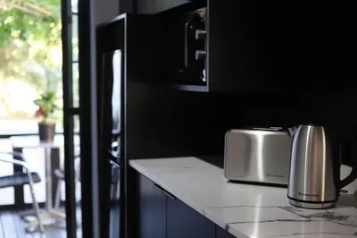 a kitchen counter with a toaster on a counter top at Trendy Cottage Hideaway in Cape Town