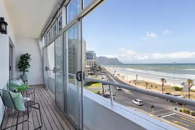 a balcony with a view of the beach at Searenity Sands in Strand