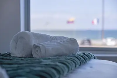 a roll of toilet paper sitting on top of a bed at Sea Spray AG04 in Bloubergstrand