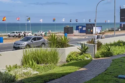 a car parked on a road next to the beach at Sea Spray AG04 in Bloubergstrand