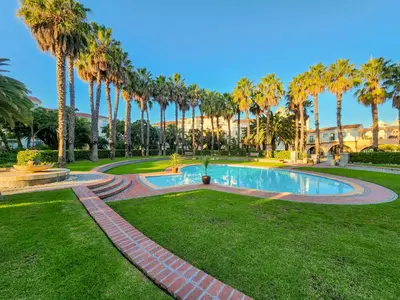 a park with palm trees and a swimming pool at Pool, Gym, self check-in,Parking in Cape Town