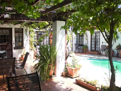 an outdoor patio with a swimming pool and trees at Linge Longa in Worcester