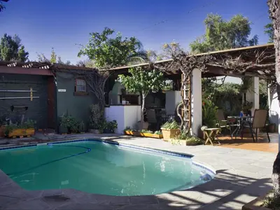 a swimming pool in a yard with a pergola at Linge Longa in Worcester
