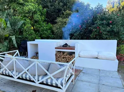 a white shelf with a pile of fire wood at Morningside Studio apartment, load shedding proof in Cape Town