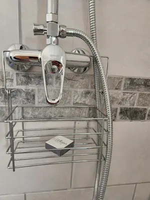 a shower rack in a bathroom with a shower head at Thys' Place in Cape Town